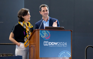 Image of two people presenting at a podium.